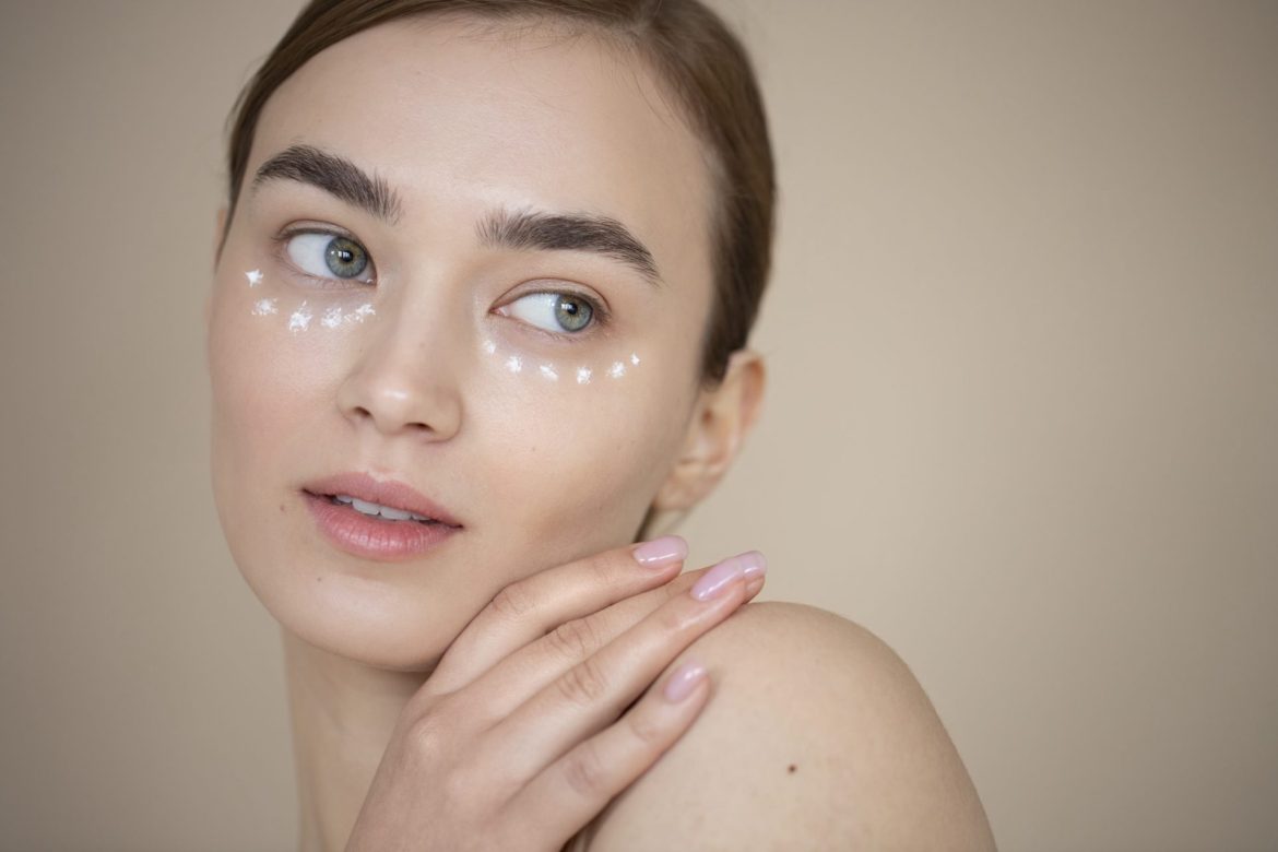 portrait beautiful woman with clear skin using eye cream