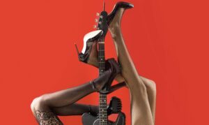 music concept. sexy legs. guitar, electric guitar. music festival, live music, concert. instrument on stage and band. fetish, sexy woman, electric guitar and legs, underwear. fetish lingerie