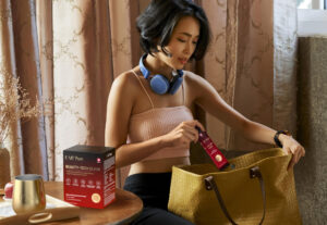 pretty young asian woman packing bag for the gym